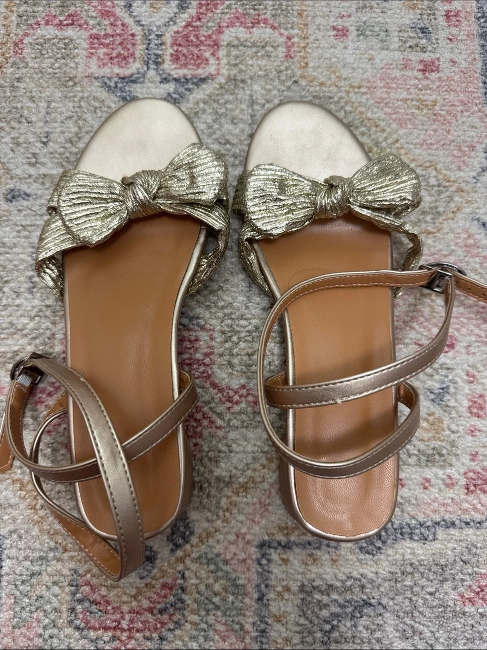 Girls gold ankle wrap sandals with bow.